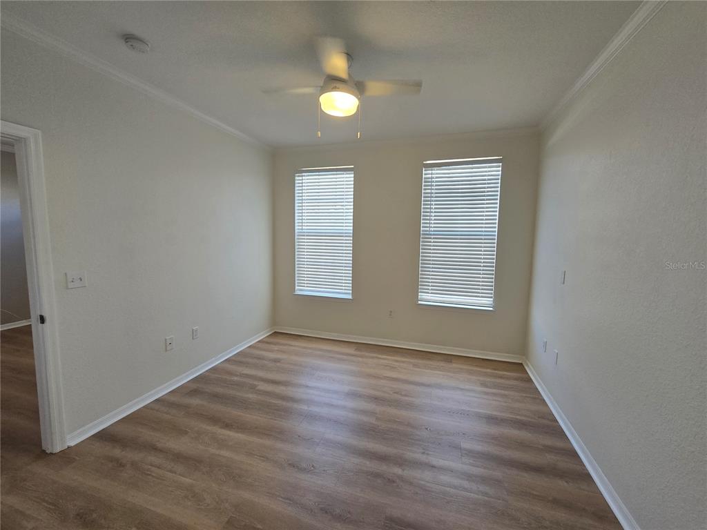 4221 West Spruce Street, Unit 2420 Tampa, FL 33607 - Photo 22 of 33 an empty room with window and wooden floor
