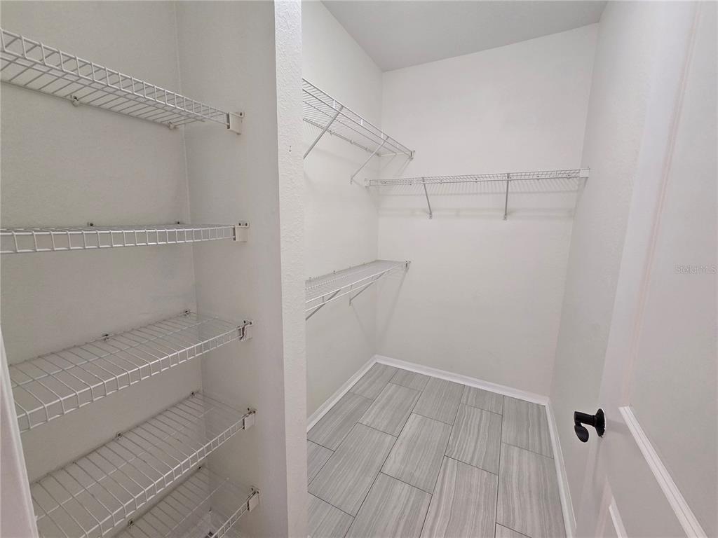 4221 West Spruce Street, Unit 2420 Tampa, FL 33607 - Photo 26 of 33 a view of walk in closet with empty racks