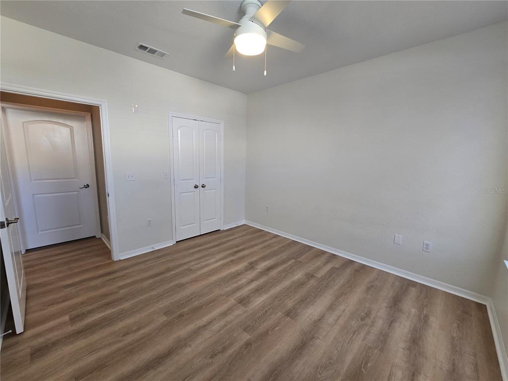 4221 West Spruce Street, Unit 2420 Tampa, FL 33607 - Photo 28 of 33 an empty room with wooden floor and windows