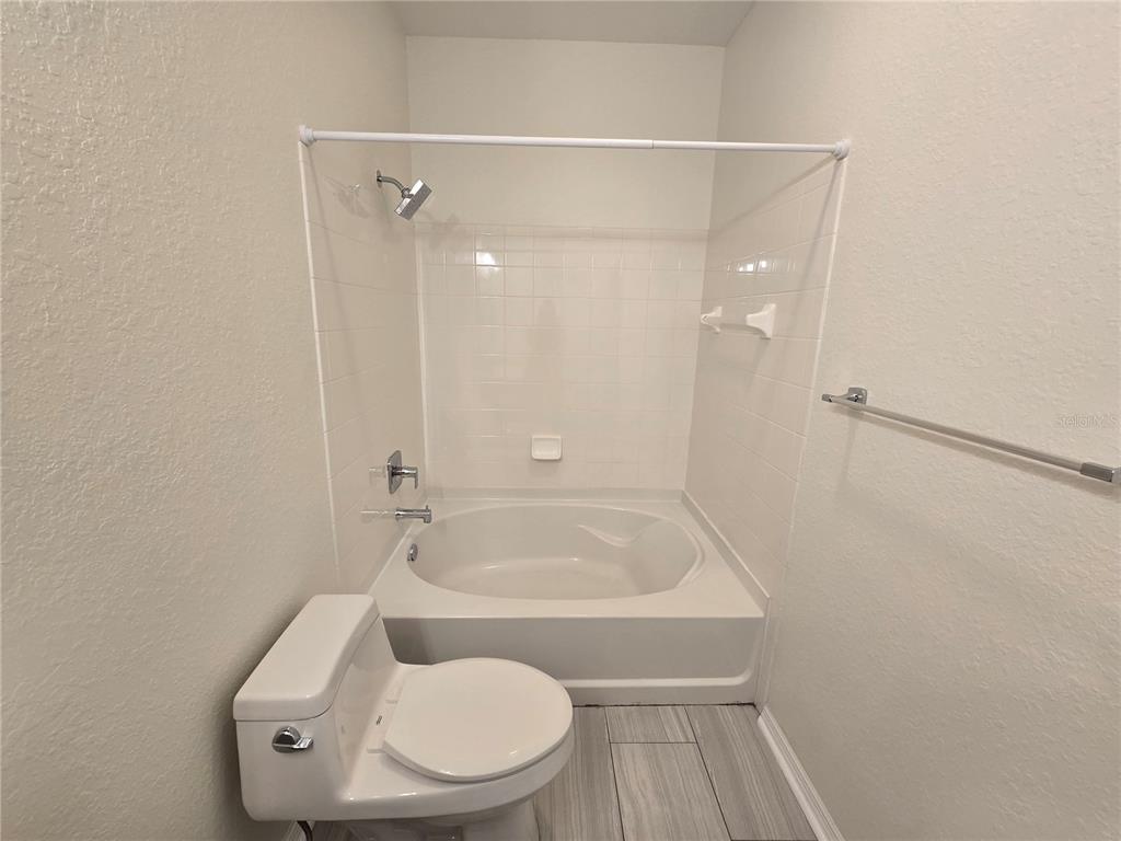 4221 West Spruce Street, Unit 2420 Tampa, FL 33607 - Photo 33 of 33 a bathroom with a toilet and shower