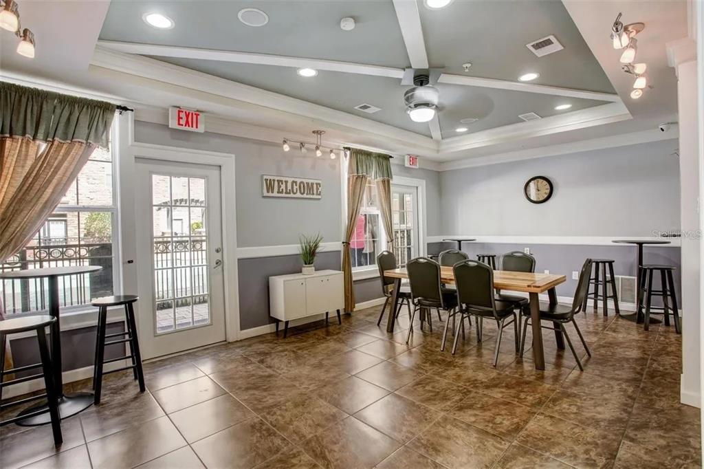 4221 West Spruce Street, Unit 2420 Tampa, FL 33607 - Photo 5 of 33 a very nice looking dining room with lots of furniture and a chandelier
