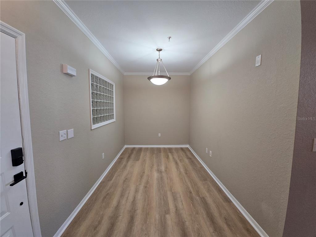 4221 West Spruce Street, Unit 2420 Tampa, FL 33607 - Photo 8 of 33 wooden floor in an empty room with a window