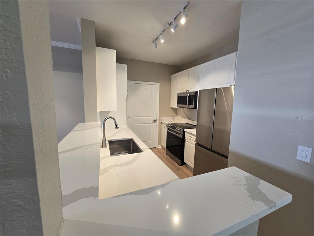 4221 West Spruce Street, Unit 2420 Tampa, FL 33607 - Photo 9 of 33 a kitchen with a refrigerator sink and stove