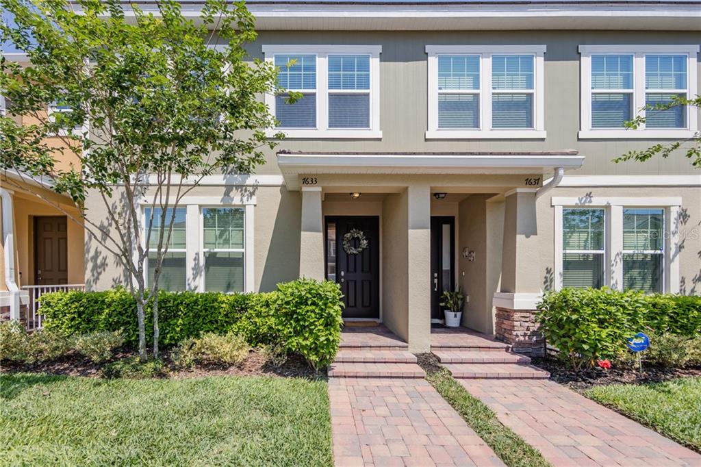 7633 Ripplepointe Way Windermere, FL 34786 - Photo 1 of 1 a view of a brick building next to a yard
