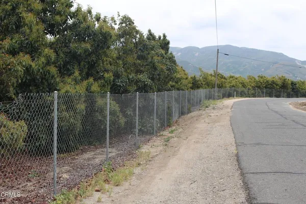 a view of a pathway with a wrought fence