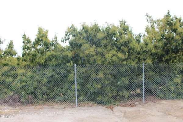 a view of a fence and trees