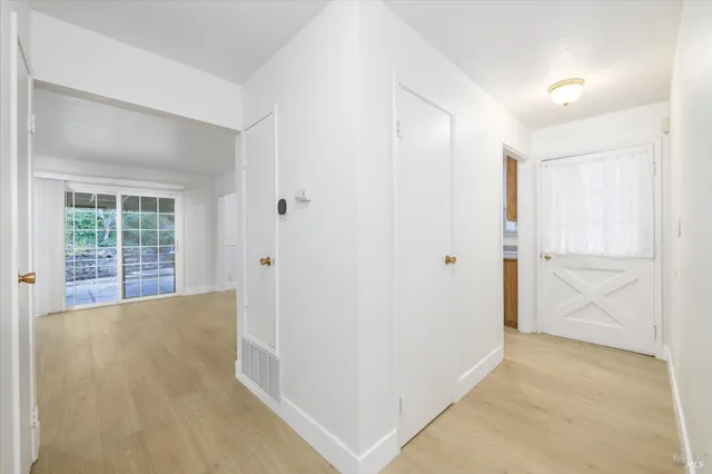 a view of a big room with windows and wardrobe