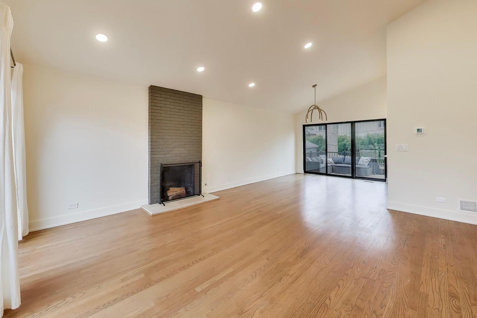 3530 Hillside Road Evanston, IL 60201 - Photo 2 of 27 an empty room with wooden floor and fireplace