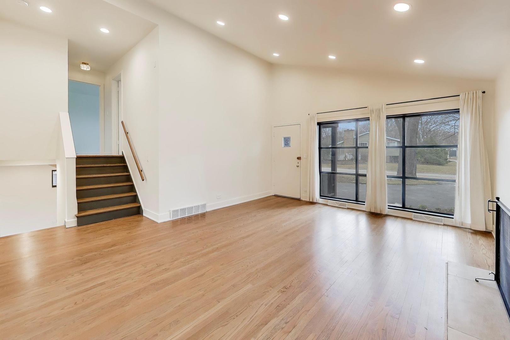 3530 Hillside Road Evanston, IL 60201 - Photo 4 of 27 an empty room with wooden floor and windows