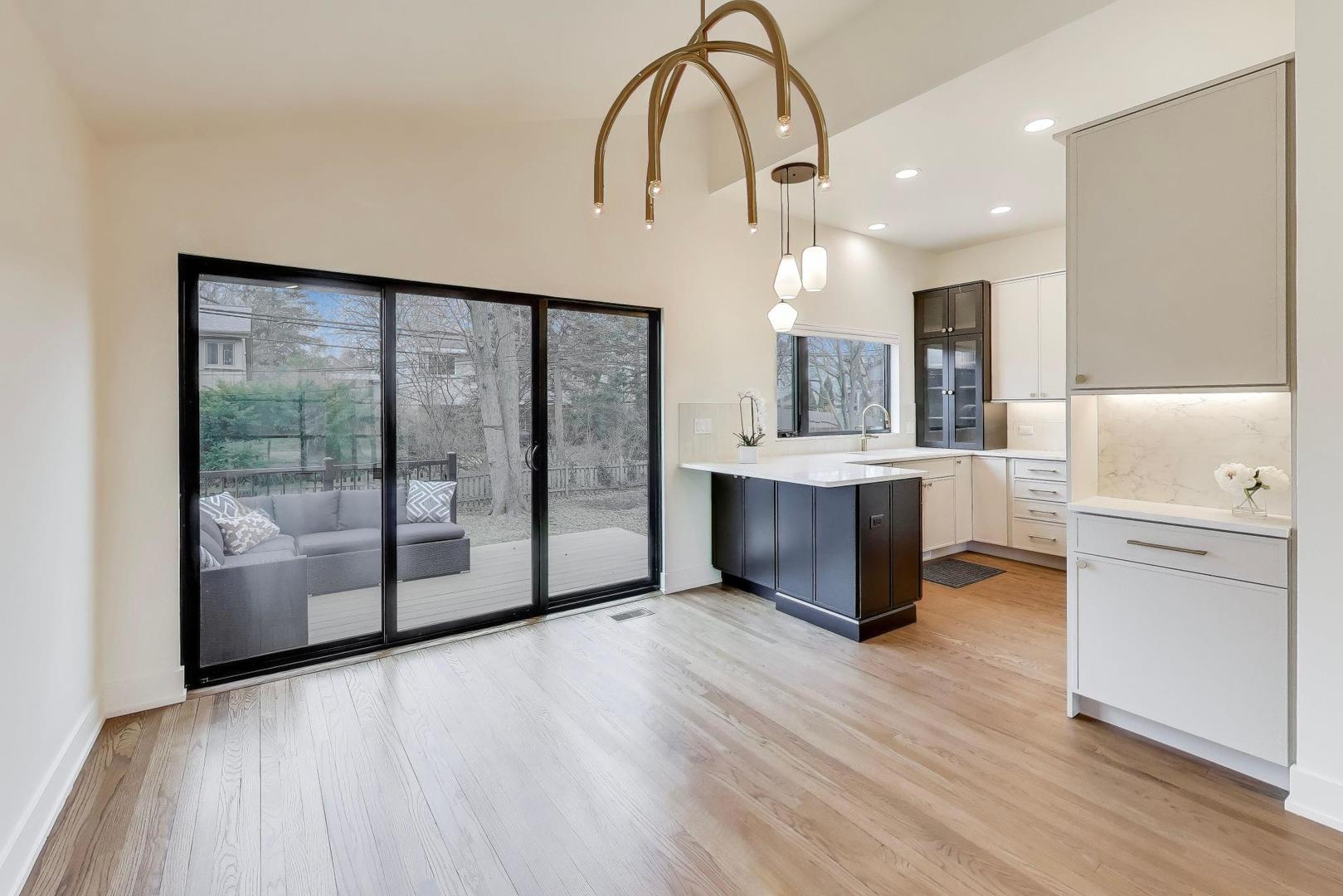 3530 Hillside Road Evanston, IL 60201 - Photo 6 of 27 a large white kitchen with a large window appliances and furniture