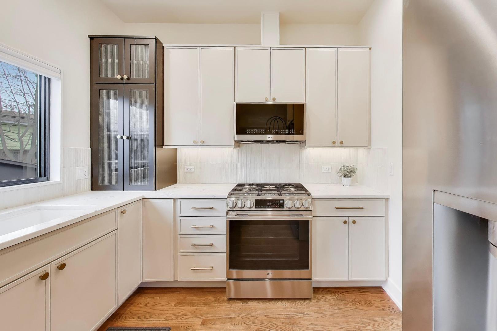 3530 Hillside Road Evanston, IL 60201 - Photo 10 of 27 a kitchen with white cabinets stainless steel appliances and sink