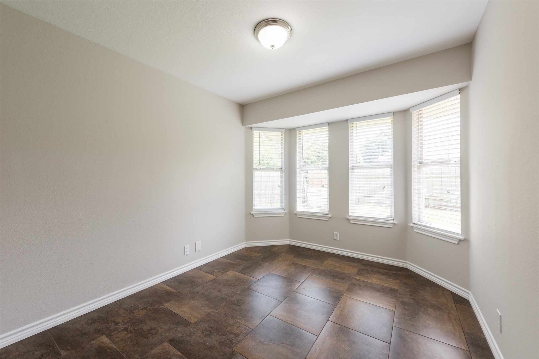 5703 Teri Road Austin, TX 78744 - Photo 6 of 16 an empty room with a empty space and windows
