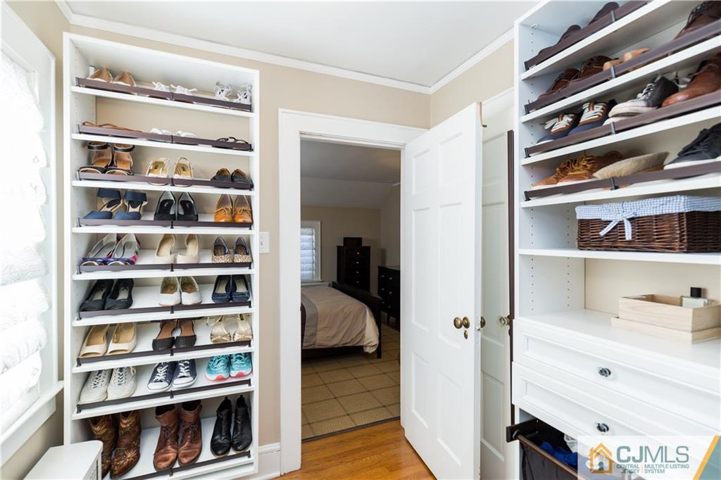 27 Oak Hills Road Edison, NJ 08820 - Photo 22 of 50 a view of walk in closet with clothes and shoes