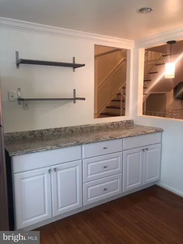 a bathroom with a granite countertop sink and mirror