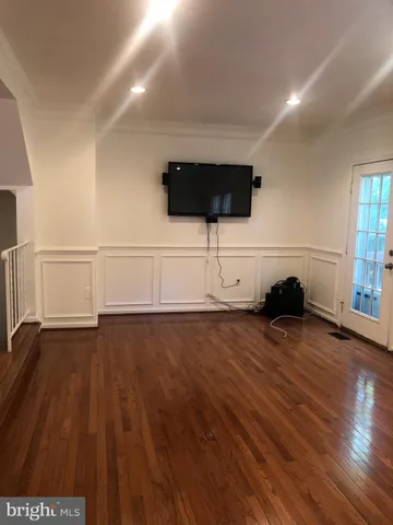 a view of an empty room and wooden floor