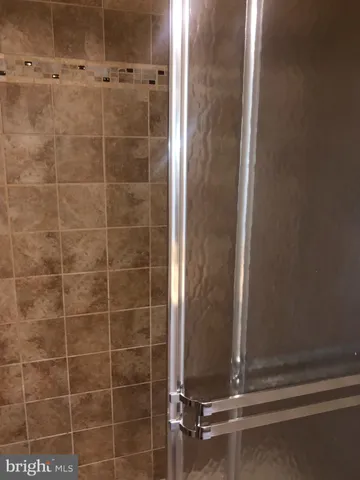 a bathroom with a glass shower door