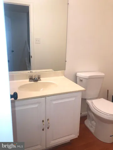 a bathroom with a sink toilet and mirror