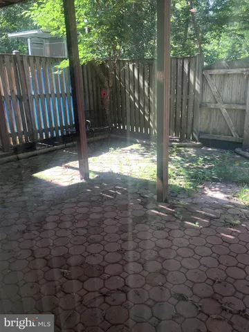 a view of a yard with wooden fence