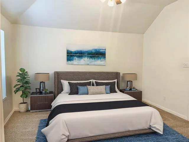 a bedroom with a bed and a potted plant