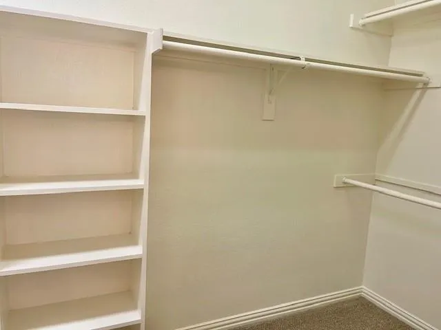 a view of an empty walk in closet