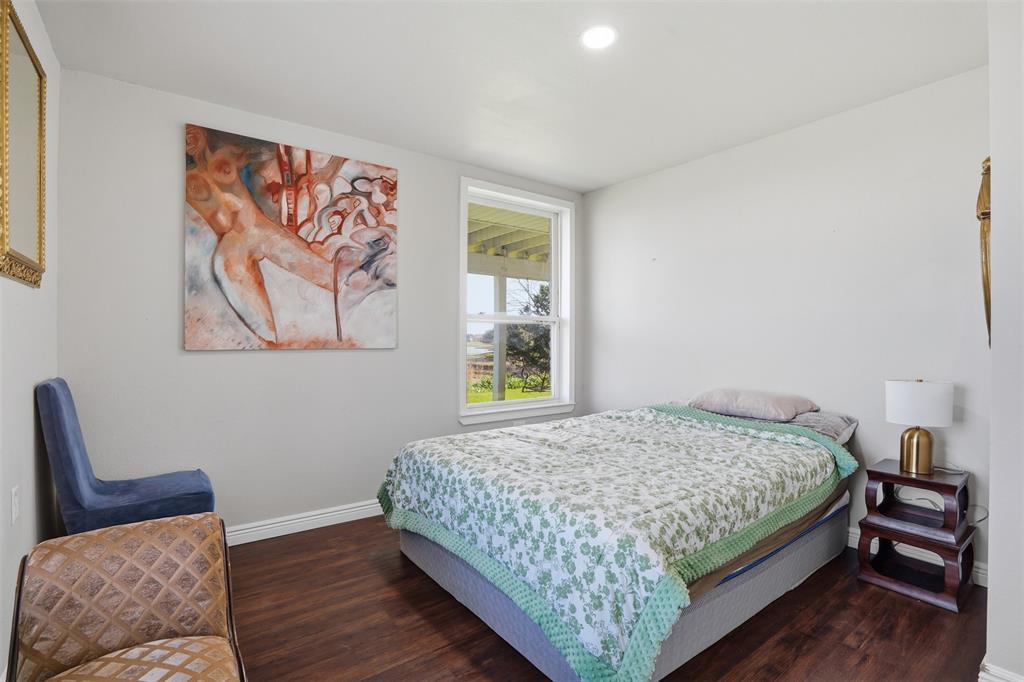 13280 Beach Club Road The Colony, TX 75056 - Photo 27 of 40 a bedroom with a bed and wooden floor