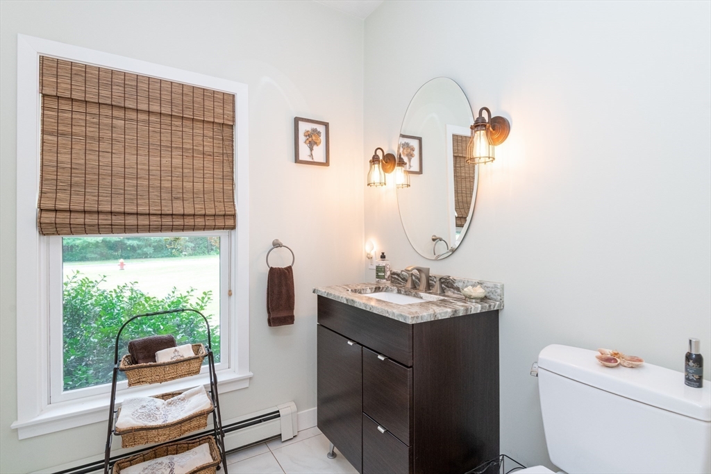 11 Hood Farm Road Ipswich, MA 01938 - Photo 22 of 42 a bathroom with a toilet sink and mirror