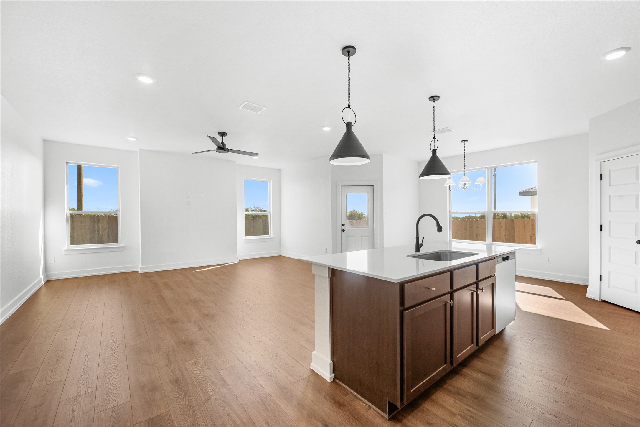 560 Gus Loop Georgetown, TX 78626 - Photo 6 of 17 a kitchen with stainless steel appliances granite countertop a sink a stove and a wooden floor