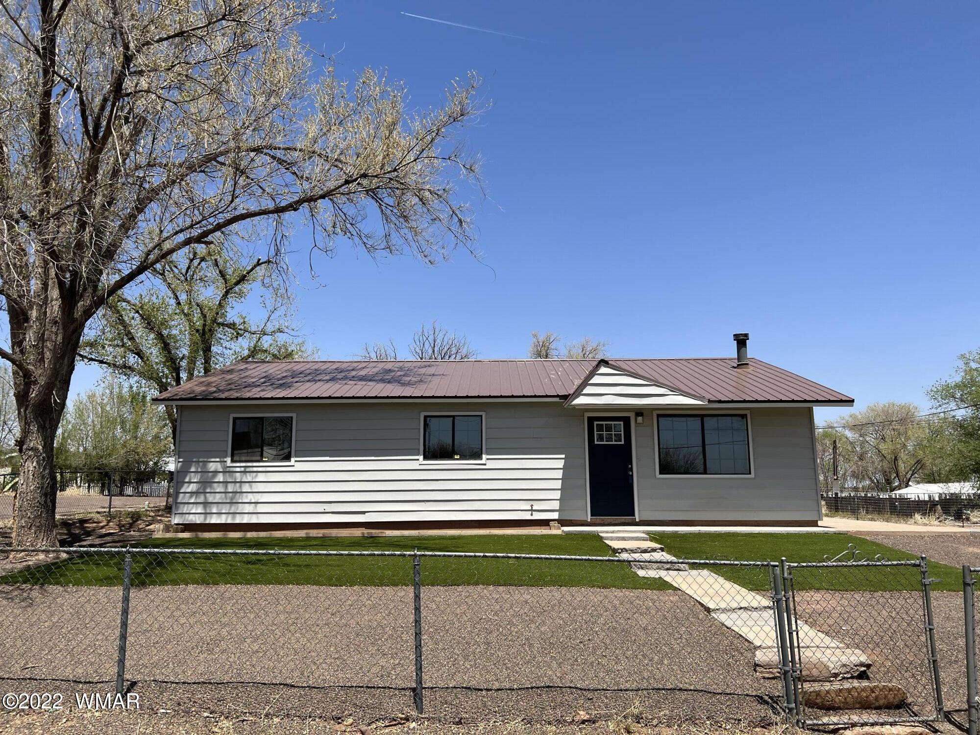 118 East 9th S Street Snowflake, AZ 85937 - Photo 1 of 19 a front view of a house with a garden