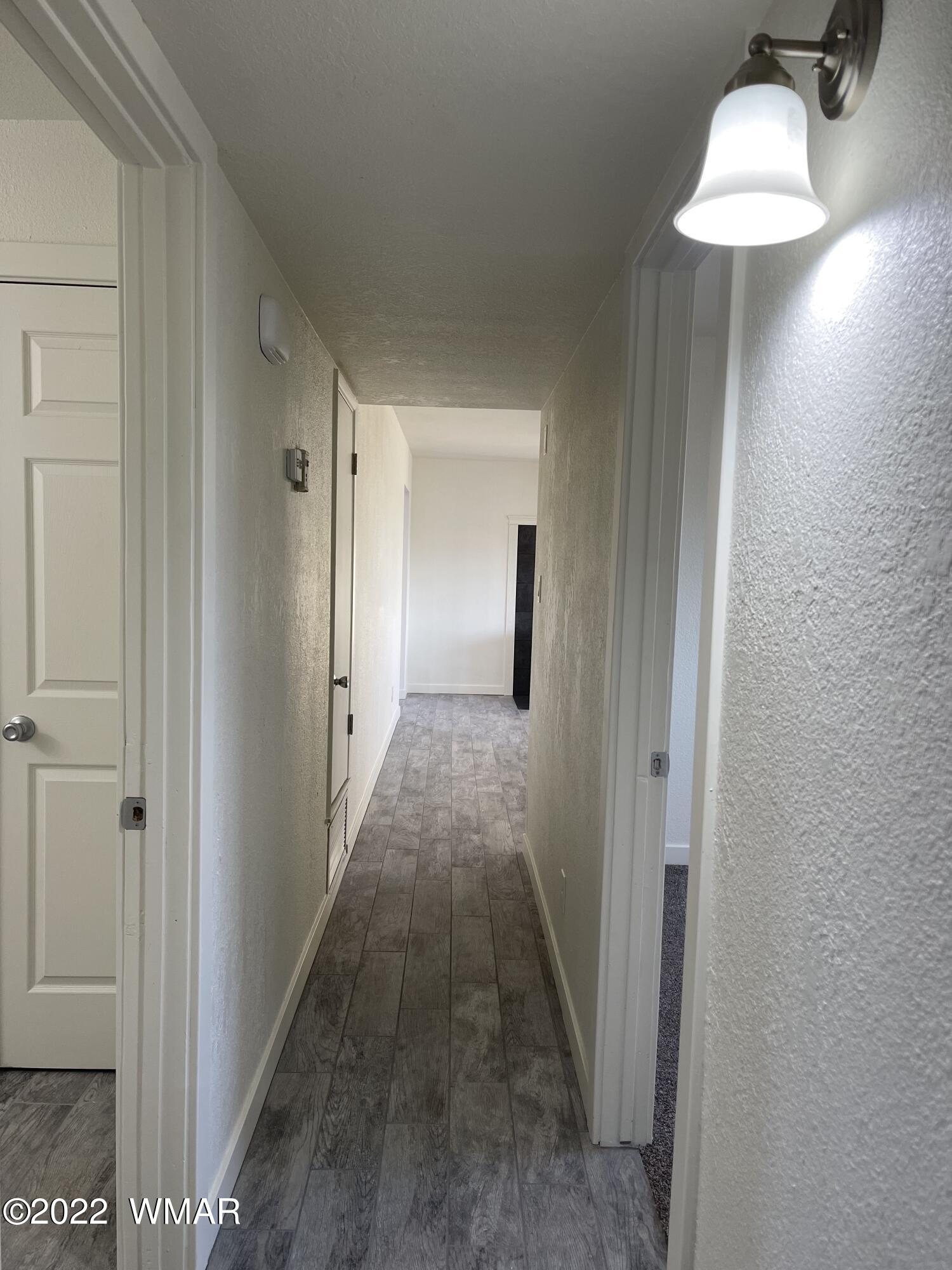 118 East 9th S Street Snowflake, AZ 85937 - Photo 13 of 19 a view of a room with wooden floor and bench