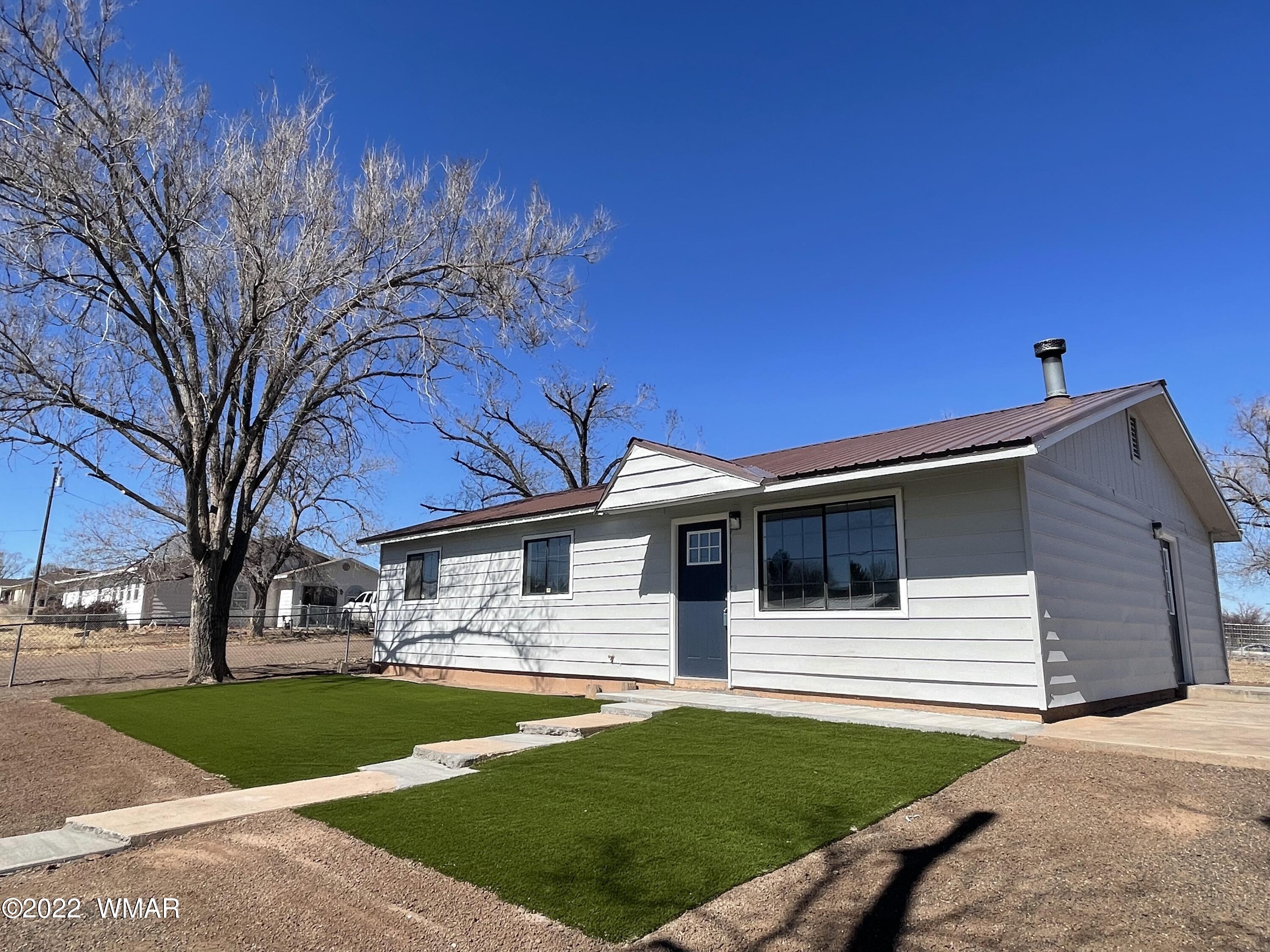 118 East 9th S Street Snowflake, AZ 85937 - Photo 4 of 19 a house that has a tree in front of the house