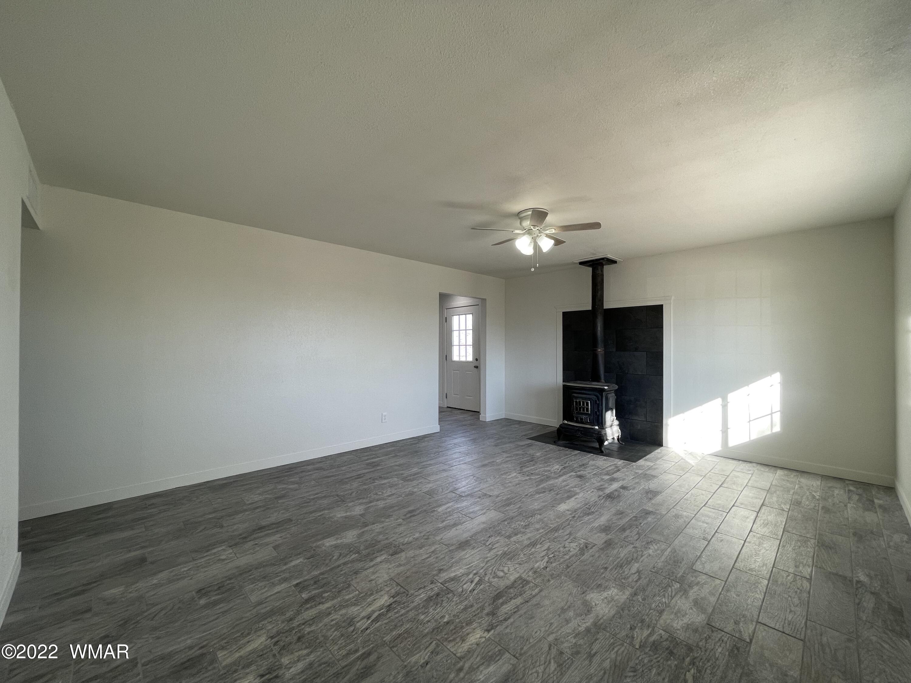 118 East 9th S Street Snowflake, AZ 85937 - Photo 7 of 19 a view of an empty room with a fireplace and a window