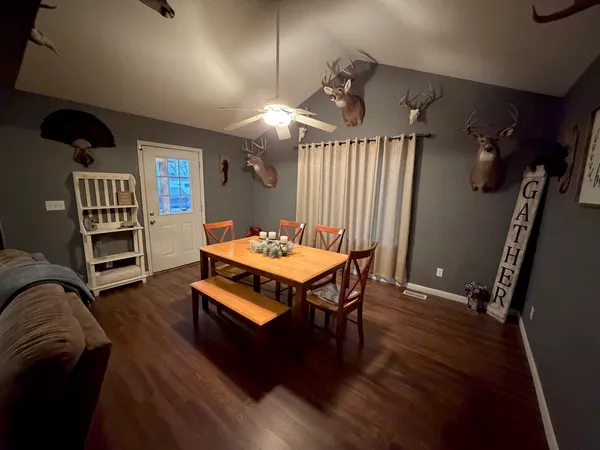 a living room with furniture a rug and a bookshelf