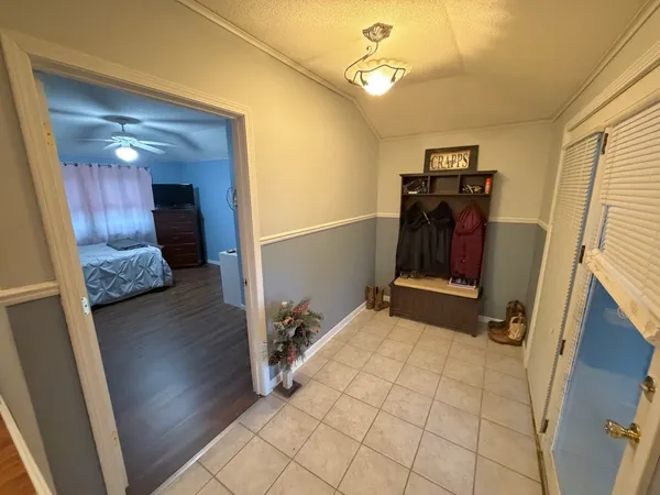 a view of a hallway to a livingroom with furniture