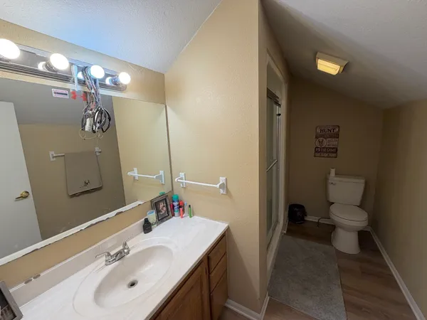 a bathroom with a sink toilet and a mirror