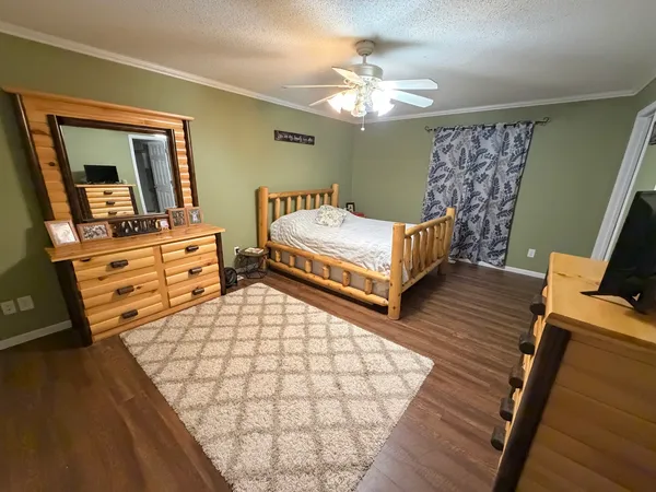 a spacious bedroom with two beds and wooden floor