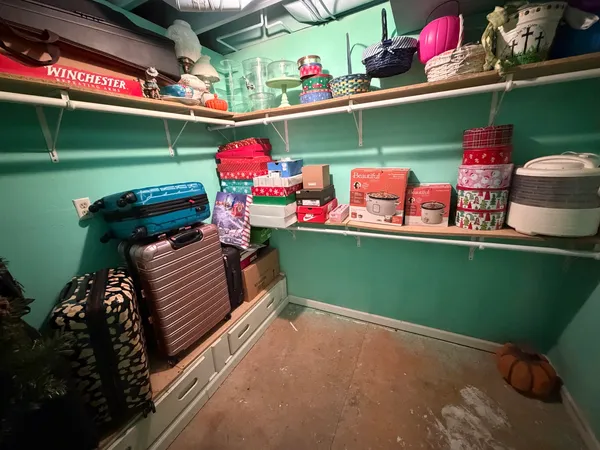 a view of a yard with plants and a table and chairs