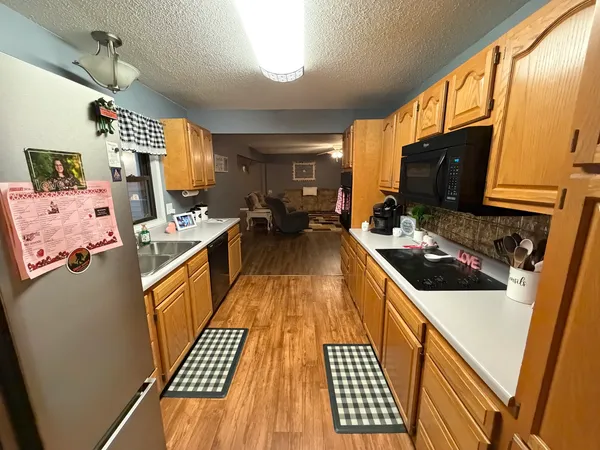 a kitchen with a sink stove and refrigerator
