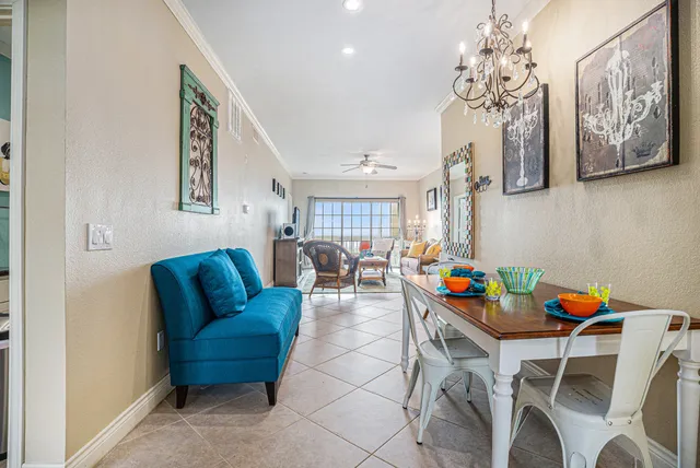 a living room with furniture a couch and paintings on the wall