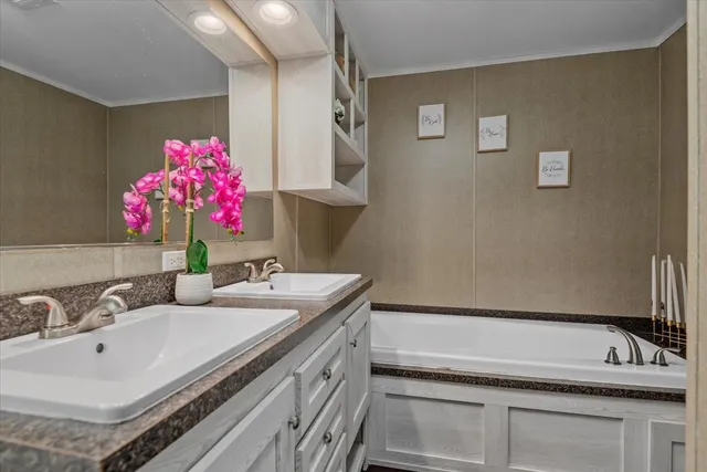 a bathroom with a granite countertop sink a large mirror and shower