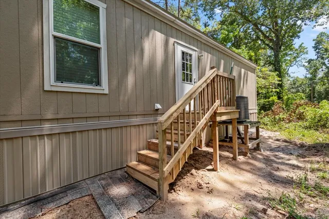 a view of backyard with deck and outdoor seating