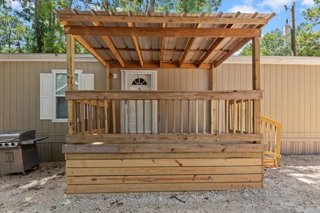 a view of backyard with wooden fence