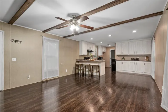 a view of kitchen with microwave and refrigerator
