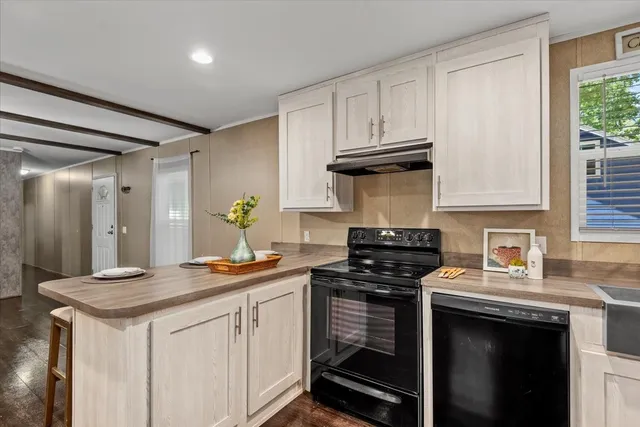 a kitchen with stainless steel appliances granite countertop a stove and a cabinets