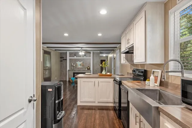 a kitchen with stainless steel appliances granite countertop a sink stove and cabinets