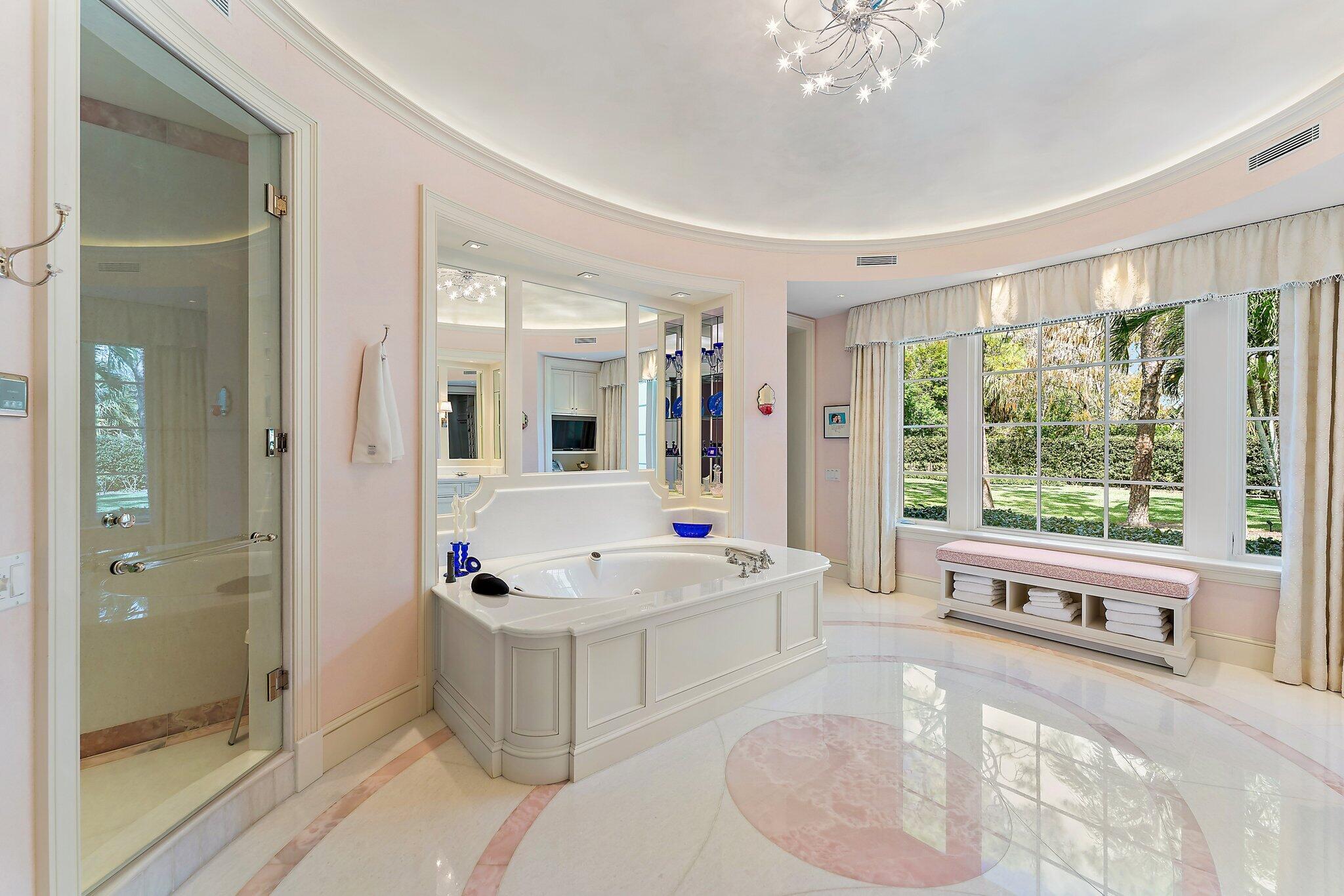 124 Bears Club Drive Jupiter, FL 33477 - Photo 21 of 67 a spacious bathroom with a tub sink and mirror