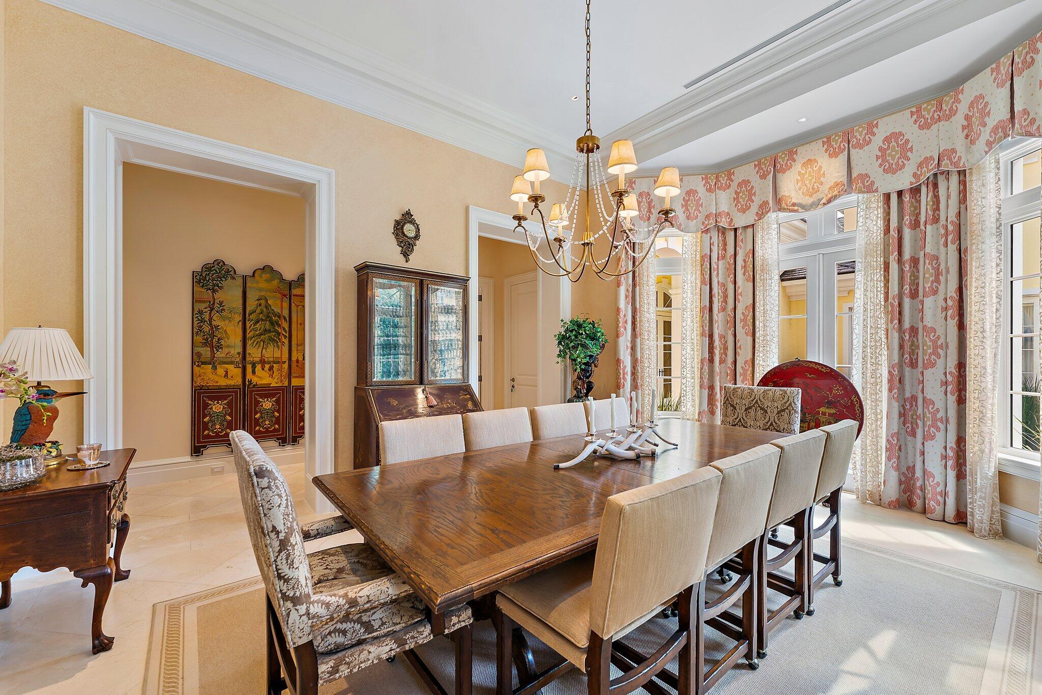 124 Bears Club Drive Jupiter, FL 33477 - Photo 27 of 67 a dining room with furniture a chandelier and wooden floor