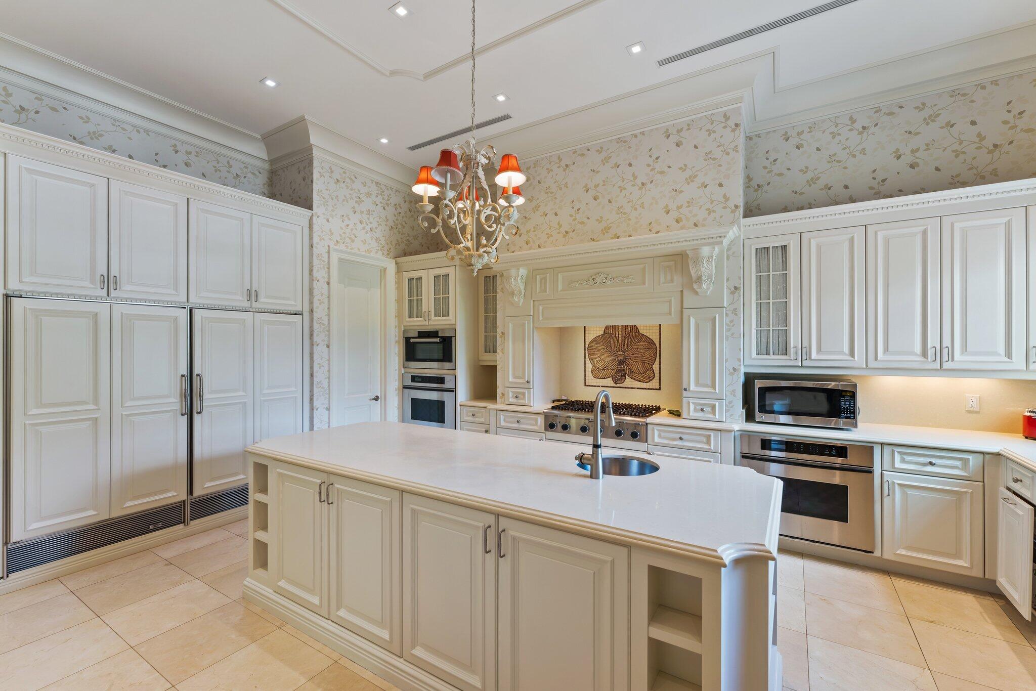 124 Bears Club Drive Jupiter, FL 33477 - Photo 29 of 67 a kitchen with stainless steel appliances a sink stove and cabinets