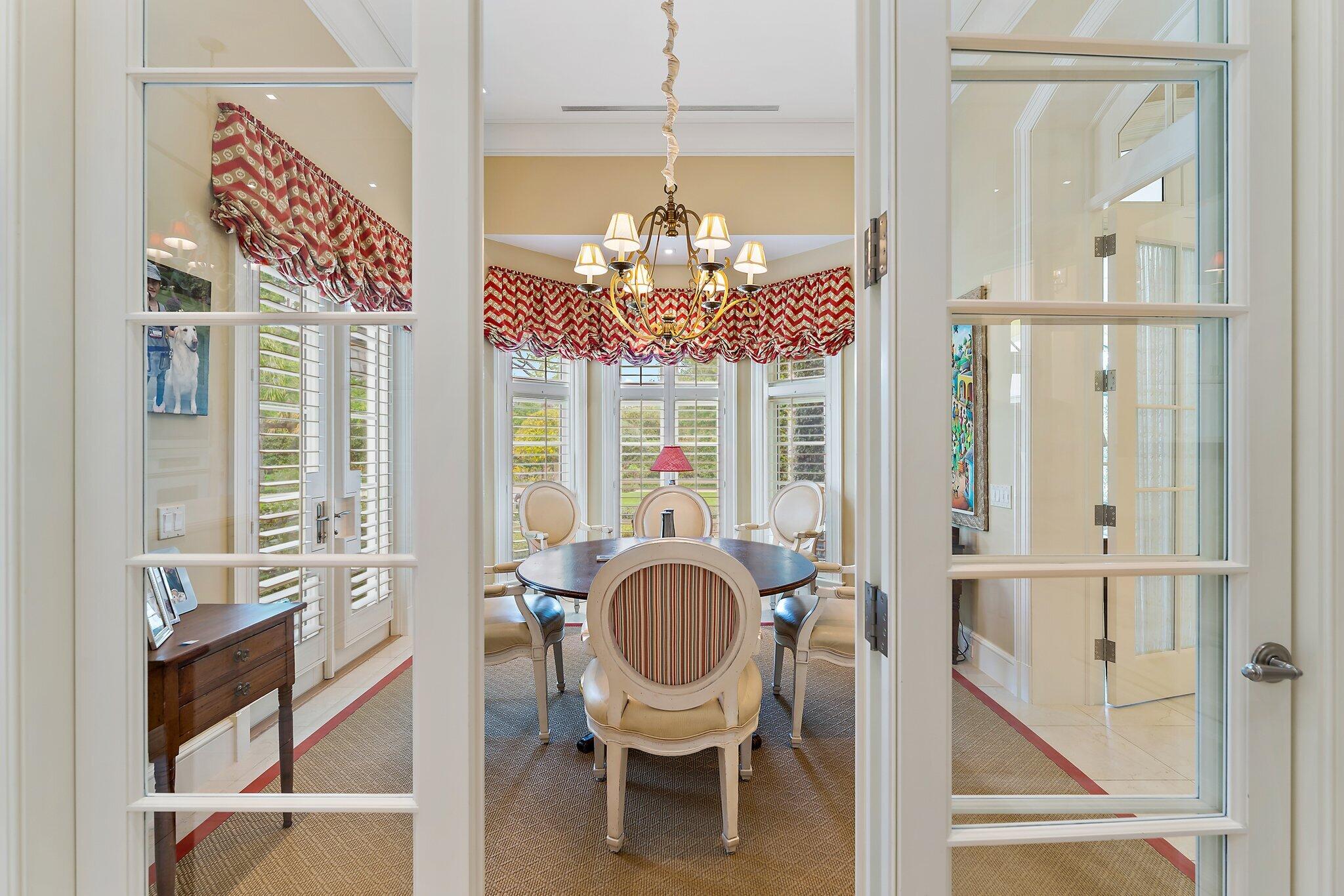 124 Bears Club Drive Jupiter, FL 33477 - Photo 31 of 67 a dining room with furniture a chandelier and a rug