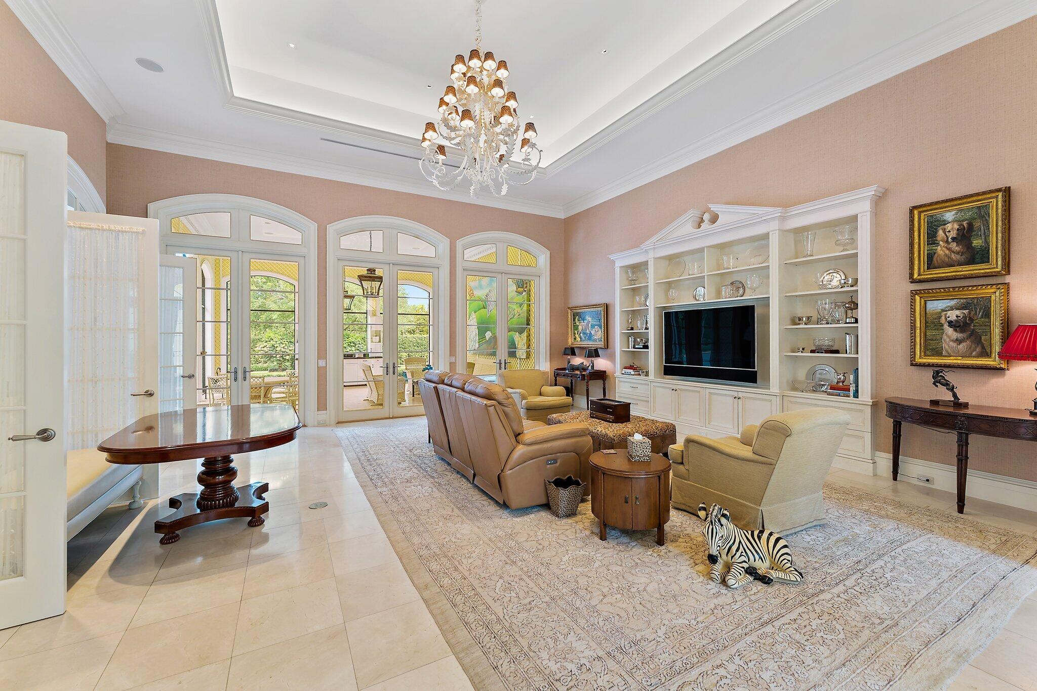 124 Bears Club Drive Jupiter, FL 33477 - Photo 32 of 67 a living room with furniture or chandelier and a flat screen tv