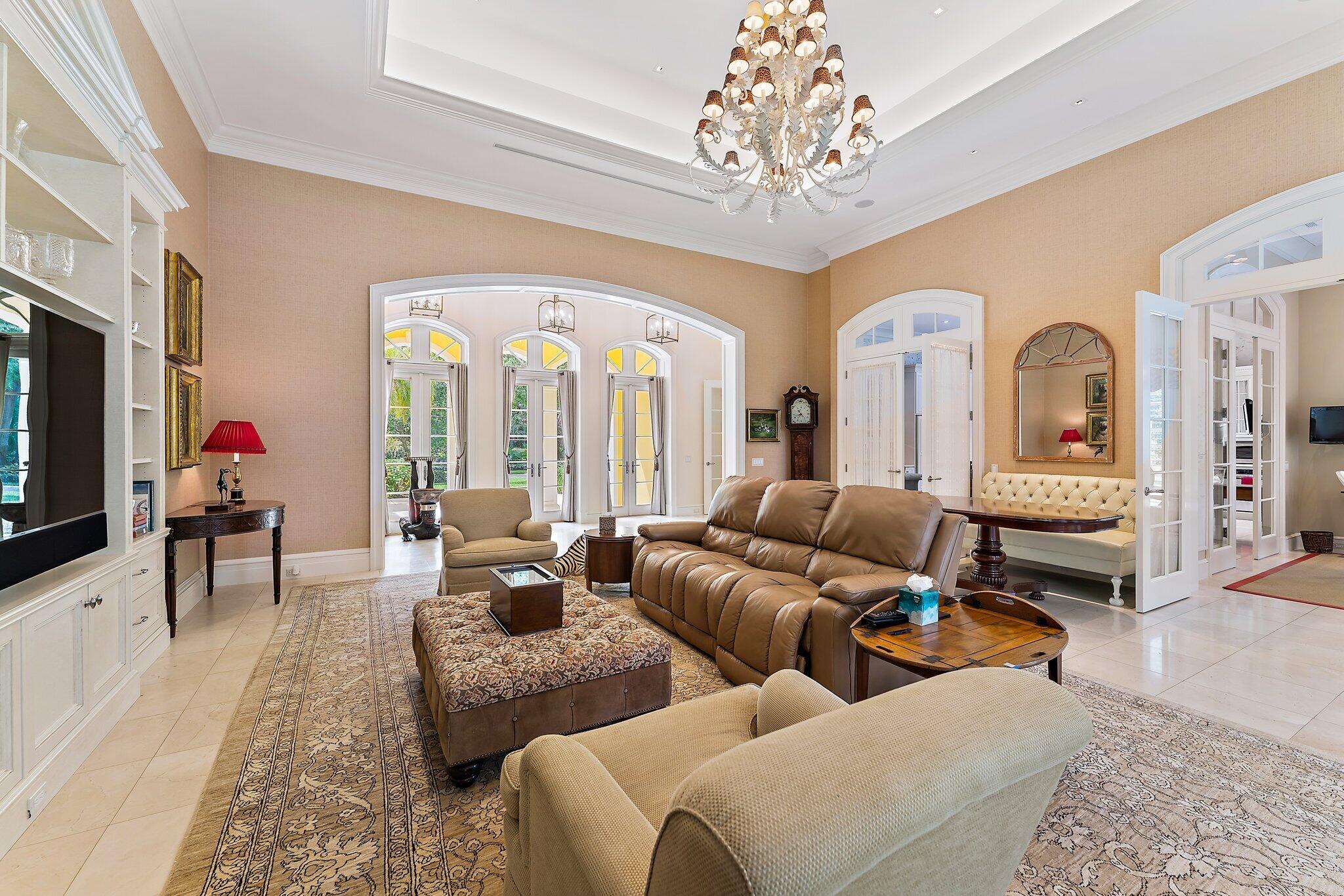 124 Bears Club Drive Jupiter, FL 33477 - Photo 33 of 67 a living room with furniture and a chandelier